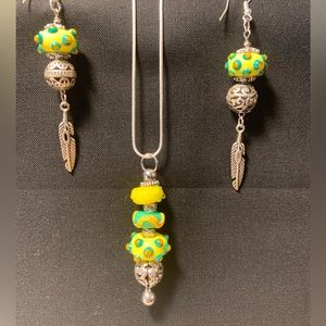 Uniquely designed hand crafted lamp work bead pendant with matching accessories